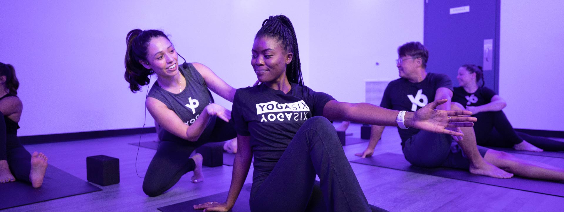 Instructors Support Members At YogaSix